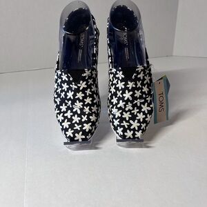 TOMS Black Canvas Slip-Ons with White Daisy Print and Yellow Centers